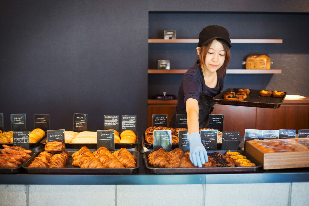 woman placing food in display