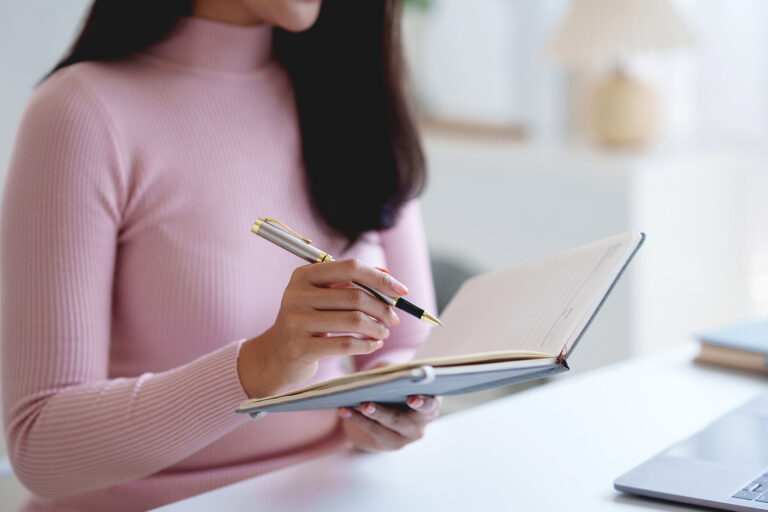woman writing in planner