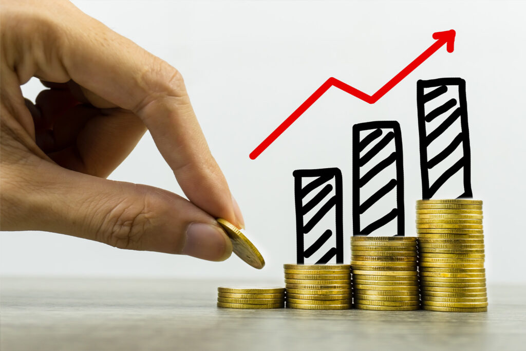 hand with stack of coins as graph