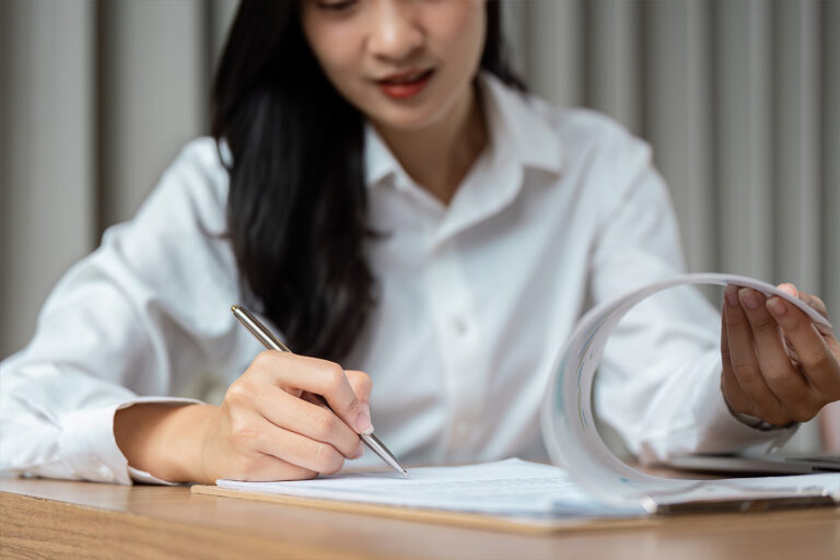 woman signing document